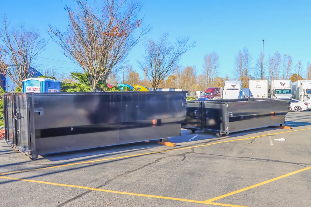 Professional dumpster rental service with roll-off container on residential driveway in Rapid City